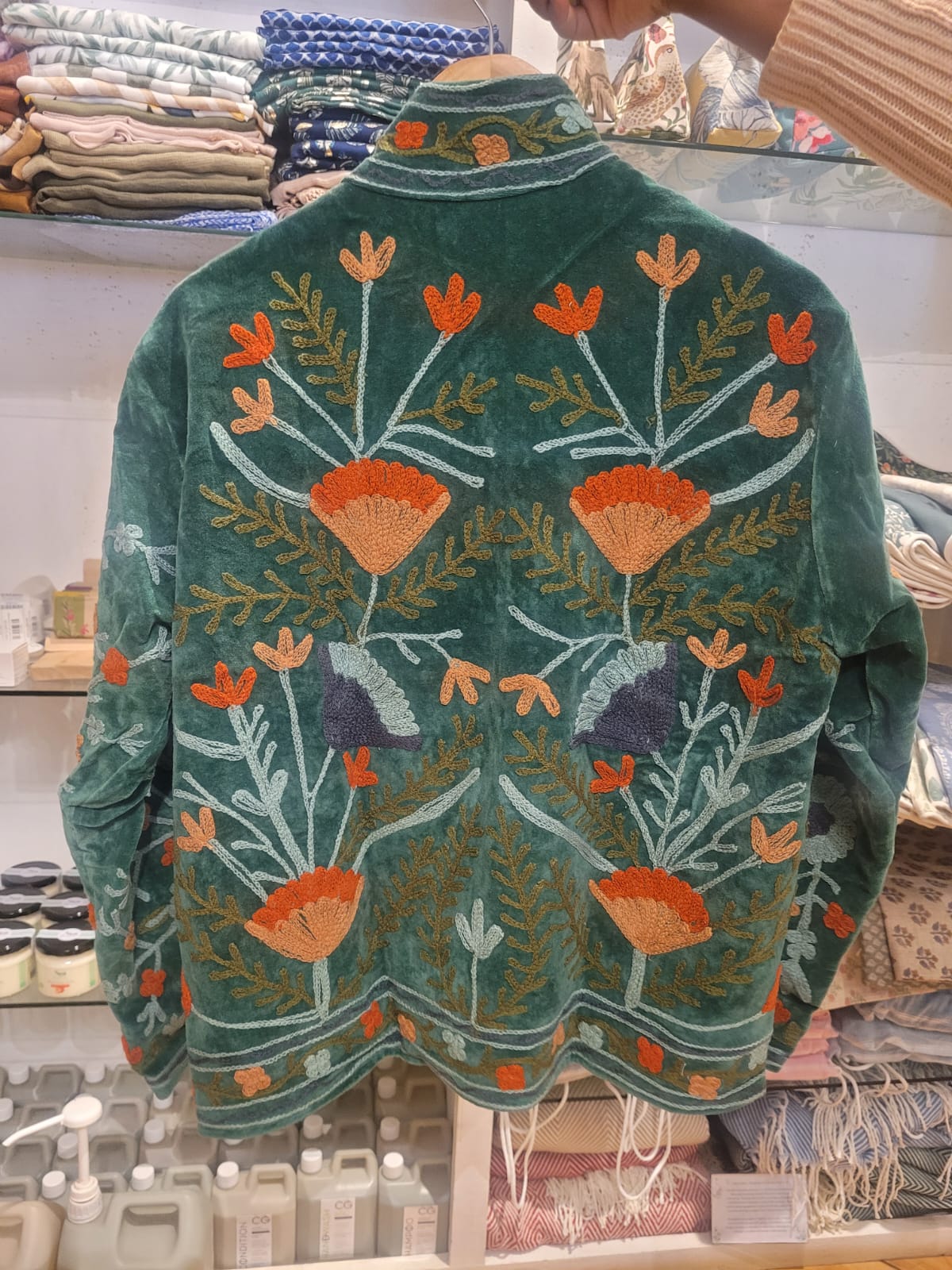 Green jacket with blue and orange flowers