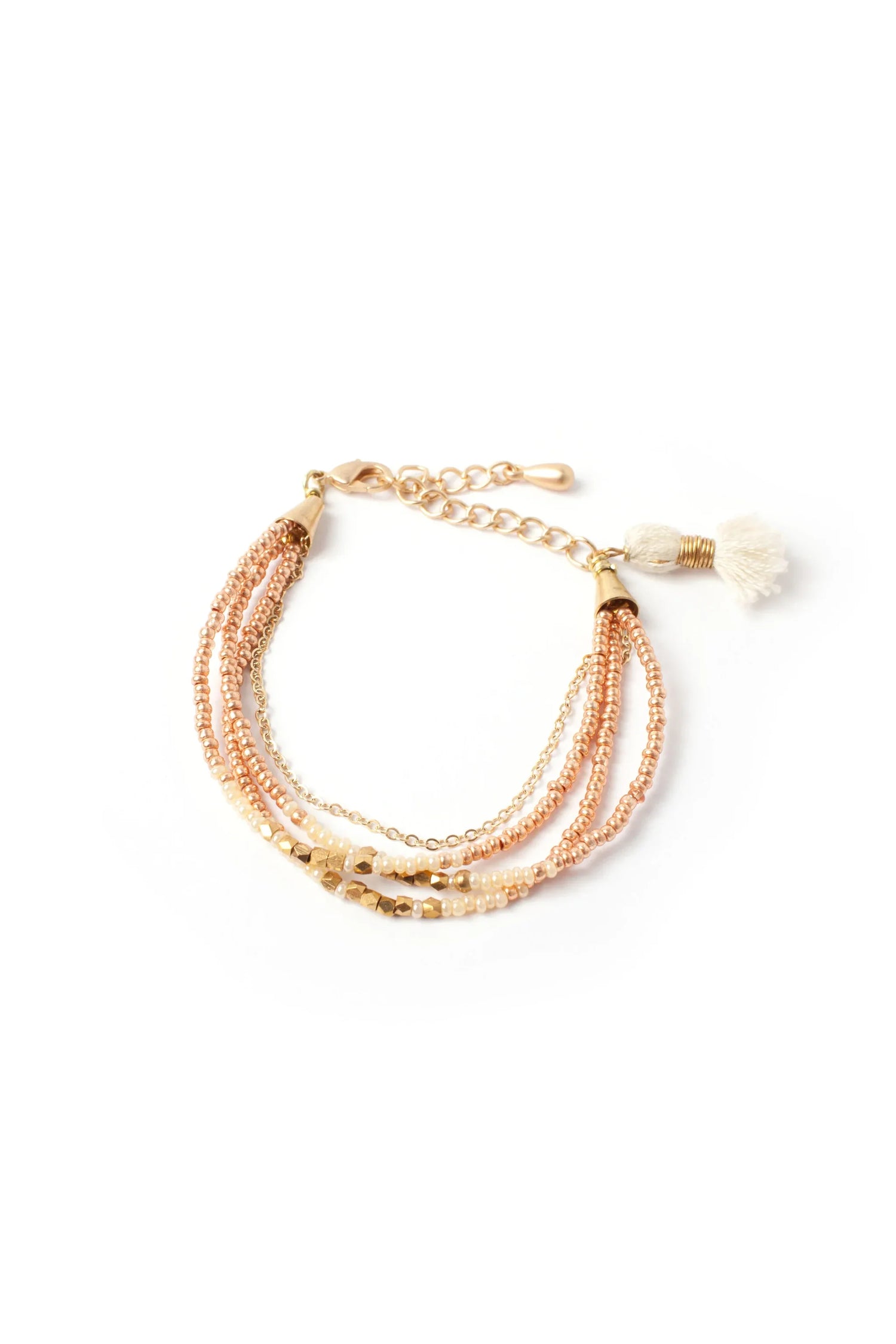 Coral beaded bracelet coiled on a neutral surface