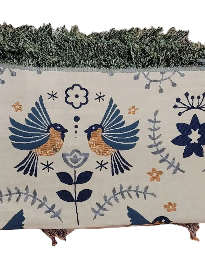 Green bird print throw blanket folded and draped