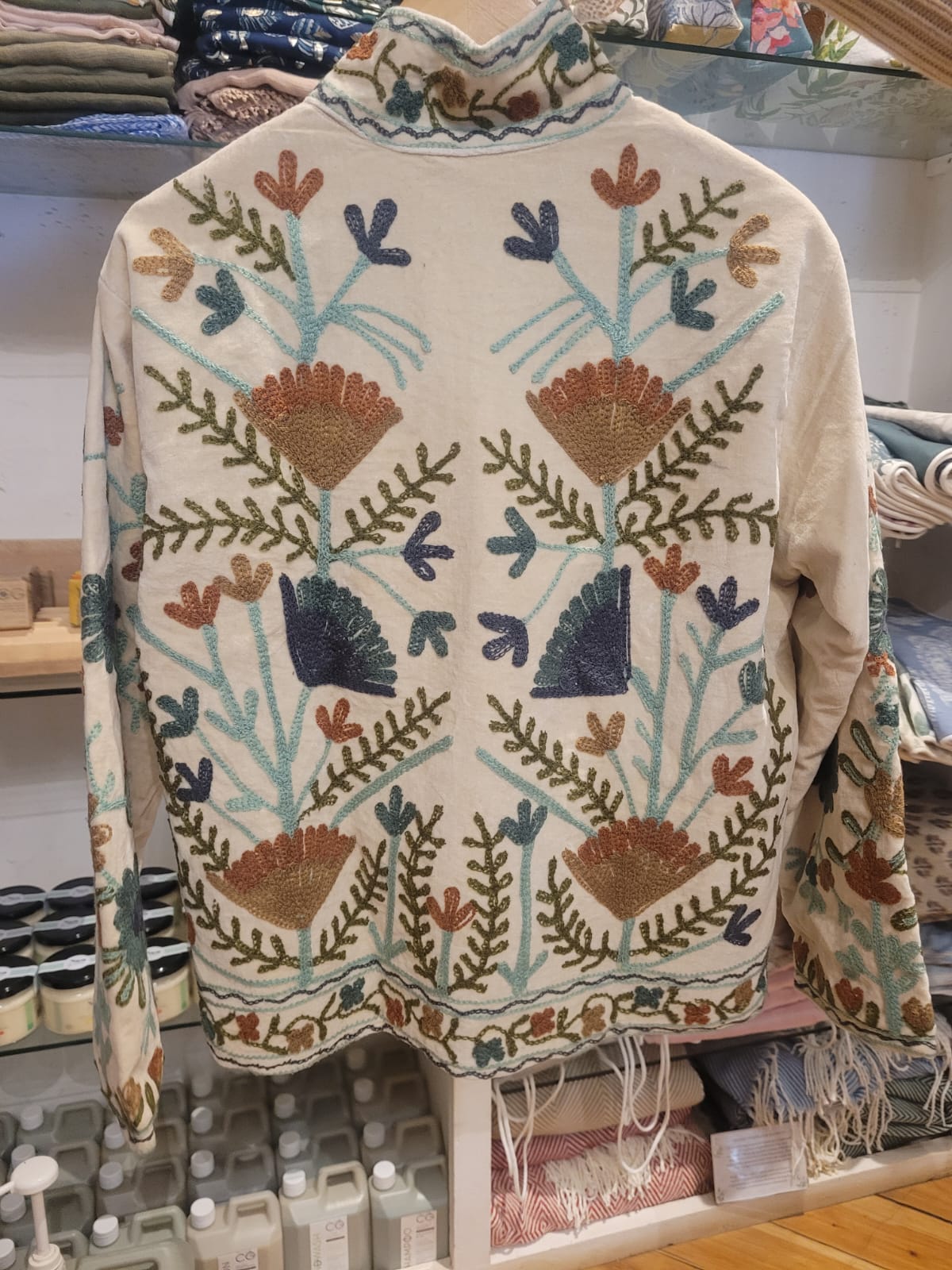 cream jacket with blue and brown flowers